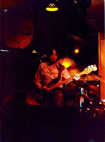 Ancient History #3 - No idea where, when, or by whom. Early '80s ? Drums suggest a blues band I did a stint with. But could be some pick-up band gig. Why am I playing a Fender Precision bass? I certainly never owned one. Kids, see the result of that lifestyle when you get old ??!!
