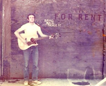 Beale St., Memphis, TN. Austin Jimmy Murphy performing on Beale St. in Memphis prior to its redevelopment (1970s).
