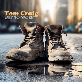 Picture of the cover of Blue's musician Tom Craig's new album Good Man Gone Bad. The cover image features Tom smiling and holding his guitar.