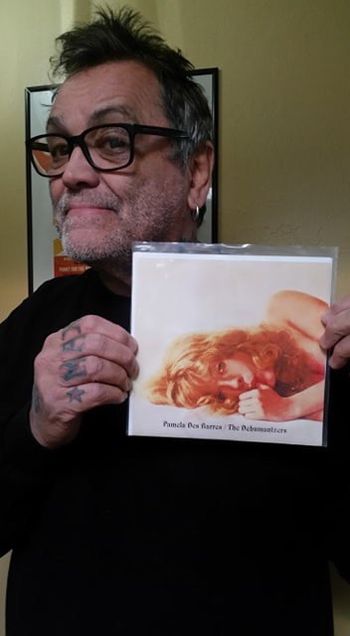Legendary San Francisco promoter, owner of Die Laughing Records and member of the Screaming Bloody Mary’s proudly display his Pamela Des Barres record on PIG Records.

