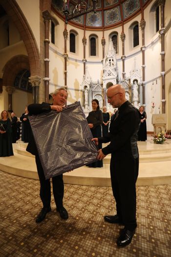 Cappella founder member Fr Martin O'Hagan presents Donal McCrisken a gift from current and former choir members. Photograph - Vincent McLaughlin
