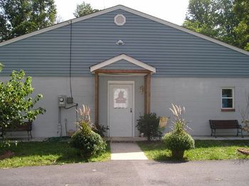 The front of the kennel with the paved driveway.
