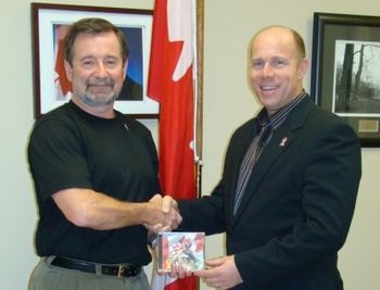 Dennis presenting a commemorative CD to Ron Cannan, MP Kelowna-Lake Country
