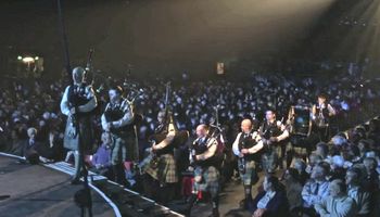 Ken Stewart leadsthe pipers onstage in the Relief of Derry Symphony, 2013
