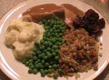 Thanksgiving Dinner:  Turkey with Gravy, Mashed Potatoes, Dressing, Peas and Cranberry Chutney
