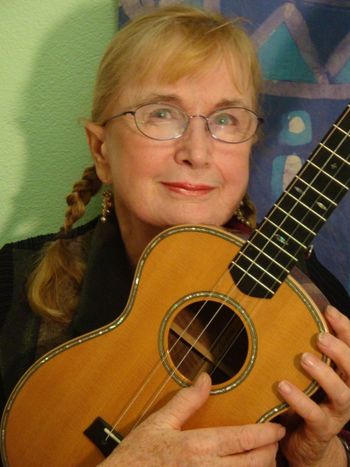 Ann Mayo Muir and her beloved baritone ukulele. Photo by Christina Muir. Go to NEWS page to get a large photo for Printed Press.

