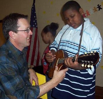 Greg teaching a new friend on the Mandolin
