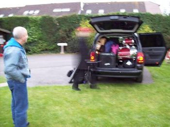 Steve watching as Andy, in a blur of activity, packs the last of the gear into the van
