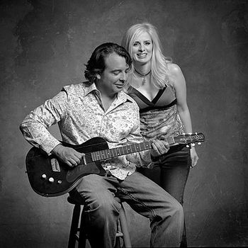 Jennifer and David with Junior Brown's first guitsteele, by Jim Mcguire
