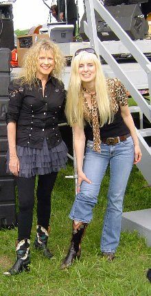 Jennifer and Becky Hobbs compare cowboy boots backstage

