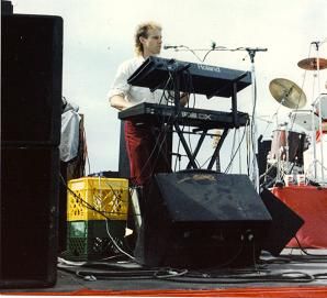 On stage at Univ of AZ with band and permed mullet, circa 1986
