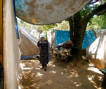 Woman in tent village
