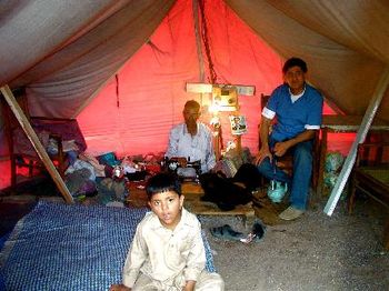Nadeem with family in tent village (this man's wife died in the earthquake, so a sewing machine was purchased for him so he could work)
