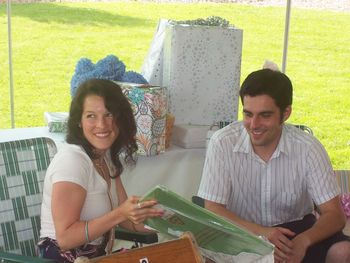 Meggan and Andrew happily continue to open gifts

