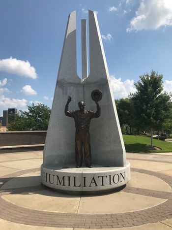 Statue from an old photo of a man with his hands up during the Tulsa Race Massacre.
