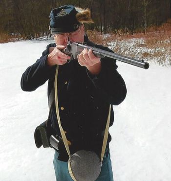 Bill Robertson firing a Spencer rifle.
