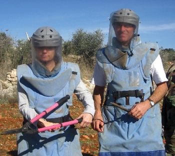 Betsy and I have a silly habit of posing ala "American Gothic" for a picture when we travel. Here is a barely tasteful pose of us with landmine clearance equipment. These are the two most important to
