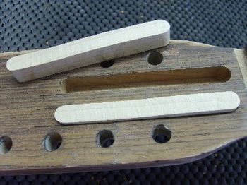 The splints are cut from straight-grain, hard rock maple, and are being glued into routed slots in the headstock.
