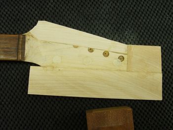 Multiple pieces of maple are grain-aligned and glued to form an oversized headstock blank....
