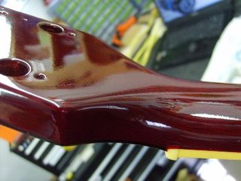 After a bit of airbrushed cherry touch-up, coats of clear lacquer are built up one thin layer at a time
