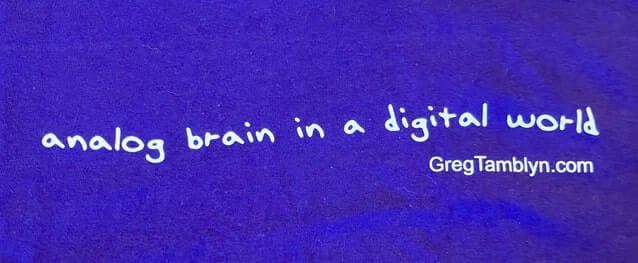 Image of Greg Tamblyn t-shirt with slogan: analog brain in a digital world, white lettering on black shirt.