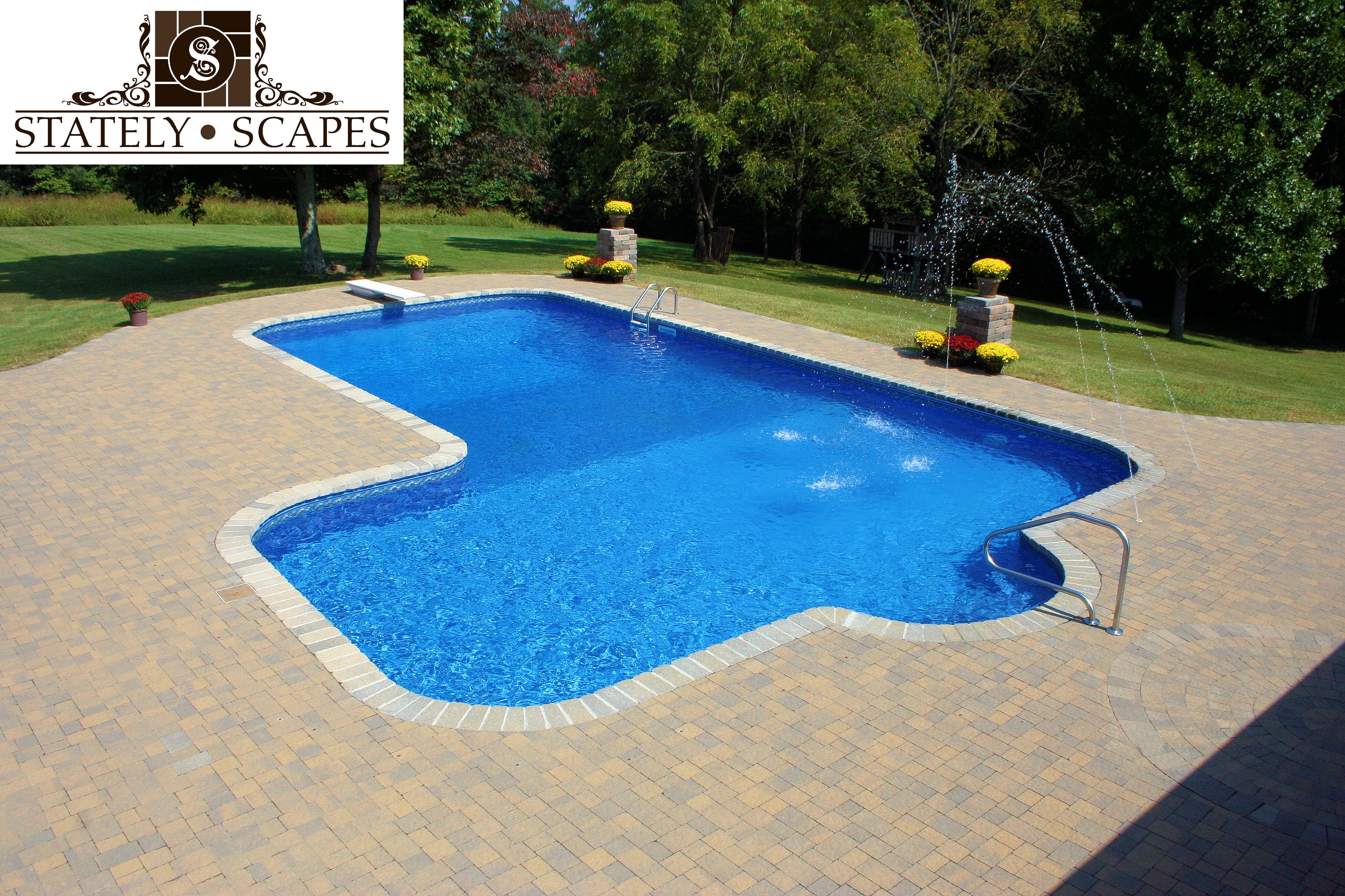 Matrix swimming pool with deck jets and paver patio.