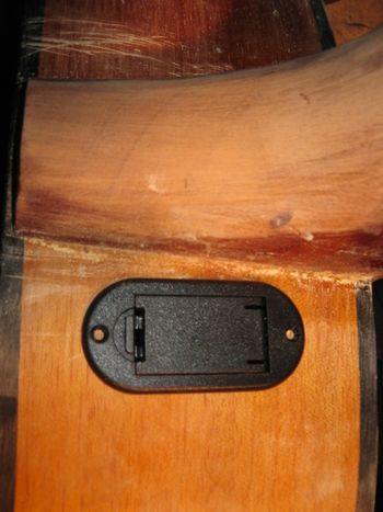 A two for one solution - this Maton had the old type of wooden panelled pick-up controls that have no battery access. (You have to loose the strings fully and reach into the sound hole to replace it.) Now there's easy battery access and the damage is concealed perfectly.
