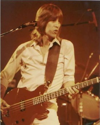 John plays his 8-string Hamer bass during a gig in 1979.
