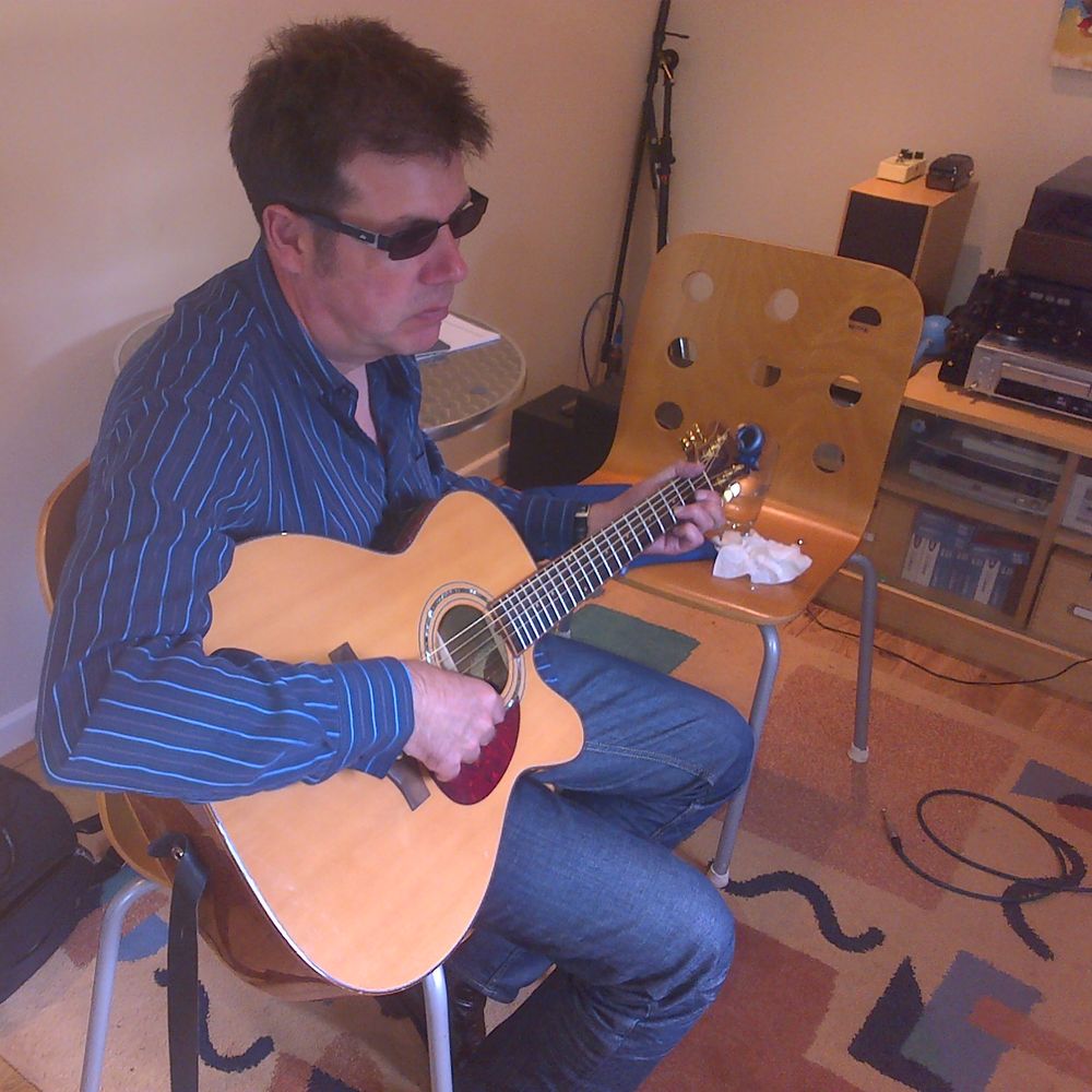 Gary Parker playing acoustic guitar