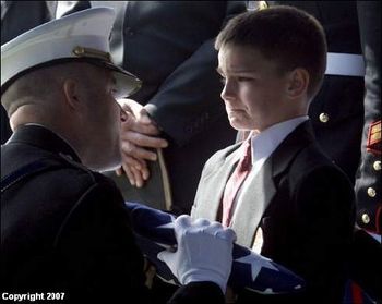 A proud, tearful son receiving the flag that draped his father's coffin. As my song says, "There's a high price for liberty......freedom is not free"
