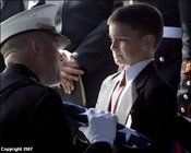 A proud, tearful son receiving the flag that draped his father's coffin. As my song says, "There's a high price for liberty......freedom is not free."
