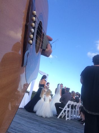 Acoustic guitarist at wedding ceremony on the lagoon deck Caves Beach
