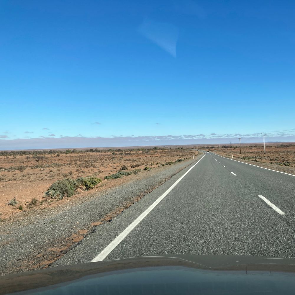 West of Broken Hill NSW Australia - just red dirt and runty shrubs as far as the eye could see. Photo by Kristine Best accompanies her story, "South Of The Border".