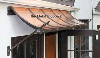 Copper Awning over doorway. Iron frame and custom iron finial accents. Location: Oakland, CA
