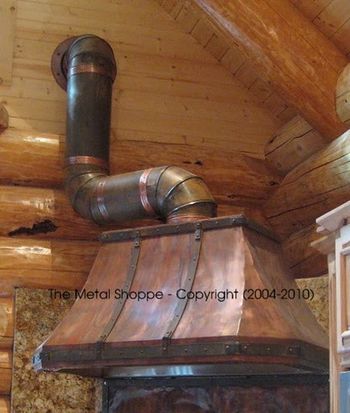Very Rustic Welded Copper Hood - French Curve with 45 degree Miters. Forged Iron Strap Accents with Antiqued Galvanized Pipe to Wall. Matching Copper Backsplash / Location: Yosemite/Wawona, CA
