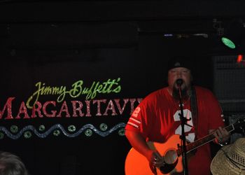 Cliff in his OSU shirt playing a show at Margaritaville.
