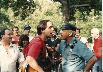 NYC Detective and I singing This Land is Your Land at the 1986 Statue of Liberty Bicentenial in Battery Park
