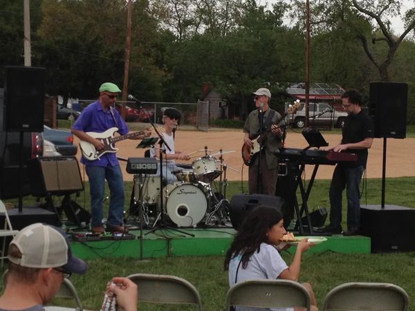 Our first gig at my daughter's elementary school festival, 2014. That's her enjoying a slice.