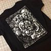 Faces & Skulls T by ERiC C. HARRiSON from GRiEF!