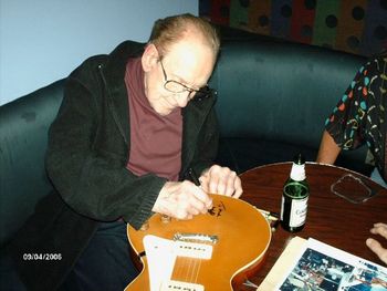 Les Paul, signing Mark's Gold-Top Les Paul guitar.
