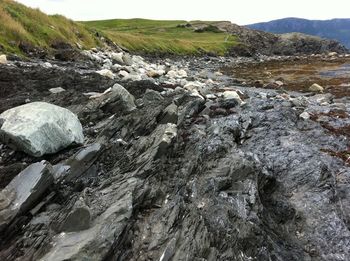 Shale jutting out of the beach in Rocky Harbour. You can see how the rock formed layer upon layer.

