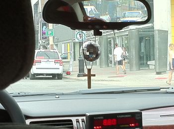 A cross and disco ball hanging from our cabbie's mirror. Don't know what it means, but interesting dichotomy.
