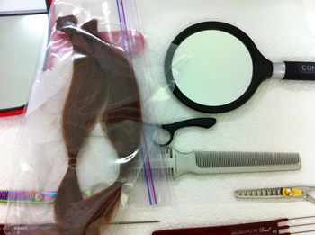 The ponytails are secured with elastics, placed in a plastic bag, and are ready for shipping.
