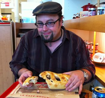 Gerald indulging in fresh bread stuffed with olives & feta.
