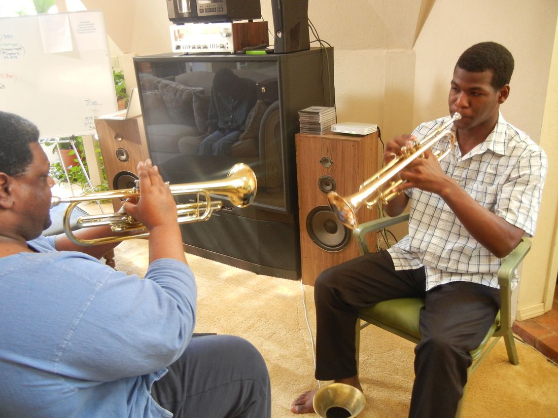 Joel Sr., Founder and Dad, practices the bass trumpet, while Aman plays his standard horn.
