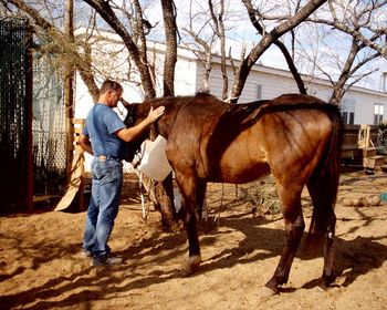 My husband, Jeff, with his TB gelding the day we went to get him. Several weeks of good food and medicine, and this gelding is now in excellent shape.
