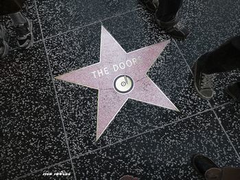 "Star" The Doors’ star of Hollywood Blvd., as people hurry by. Located in front of the Hard Rock Cafe, which also houses the original handwritten lyrics for L.A. Woman, and Morrison’s infamous brown leather pants, of Hollywood Bowl and the Miami concert fame.
