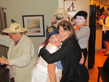 joanie being hugged by kathy, the halloween  party hostess
