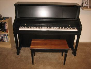 Same 1964 Kohler& Campbell Studio Piano after we filled all the scratches and dents, Put a new Satin Black Urethane finish on it and replaced the key tops. It also had some mechanical work done as well.
