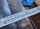 Bell Howell movie screen and lamp.